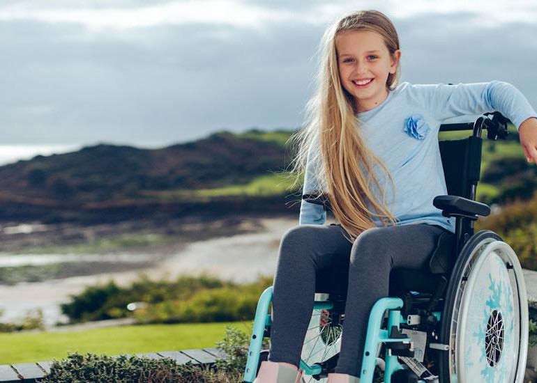 Junior on a wheelchair with a landscape background
