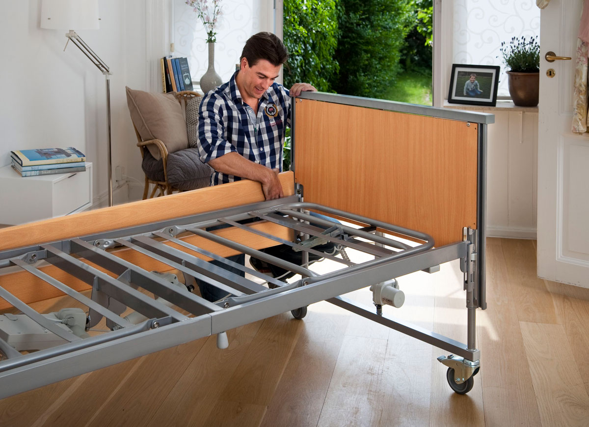 Man putting a reclining bed together