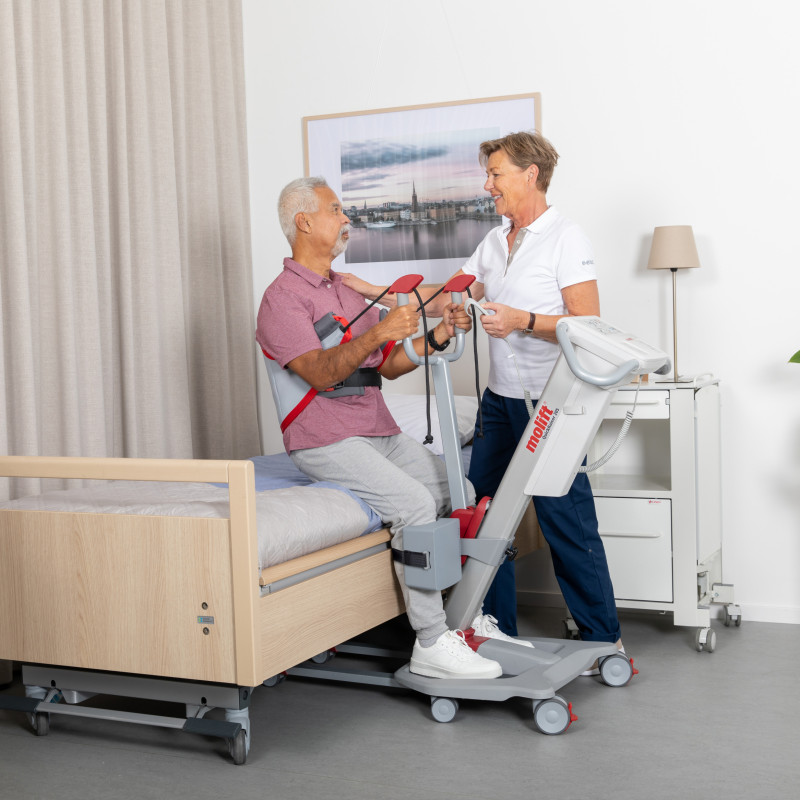 Carer and patient using a lifting device