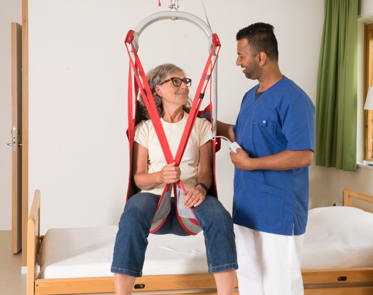 Carer and patient with a hoist