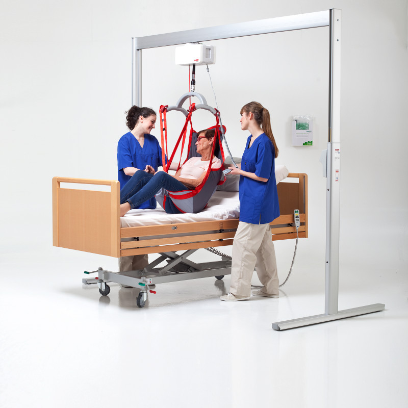 Two carers with patient using a hoist