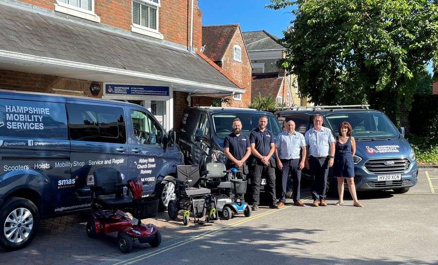 Hampshire mobility services team with their branded vehicles