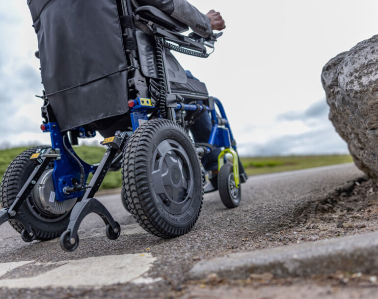 A person sitting on a powered wheelchair